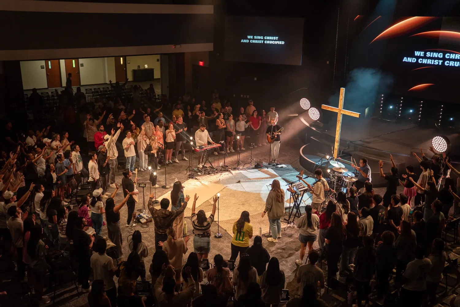 Young adults worshipping in the round at The Grove